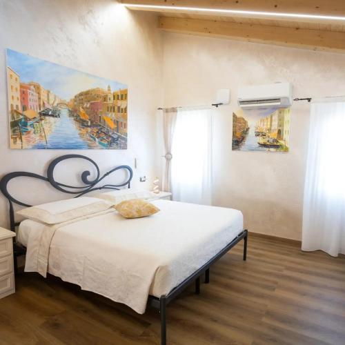a bedroom with a bed and a painting on the wall at Dal Doge - Guest House in Chioggia