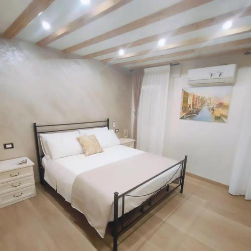 a bedroom with a large white bed in a room at Dal Doge - Guest House in Chioggia