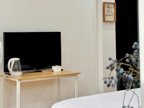 a television sitting on a table in a bedroom at Cloudy Homestay Hoi An in Hoi An