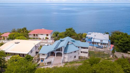 an aerial view of a house with blue roofs at Villa Ti'twoine in Pointe-Noire