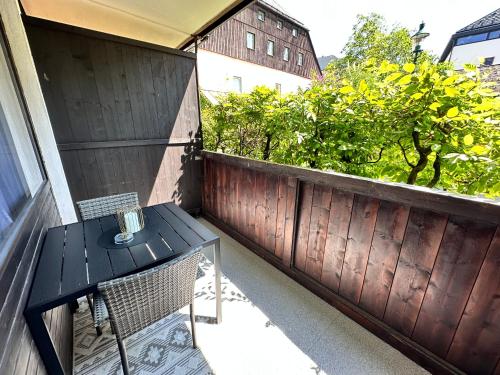 a black table and chairs on a balcony at Urlaub im Zentrum von Bad Aussee in Bad Aussee