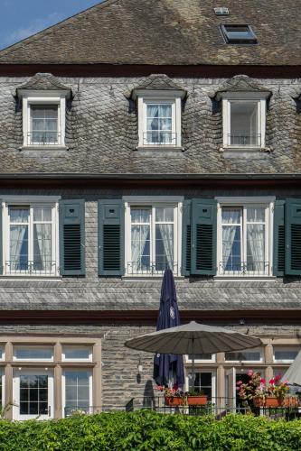 a building with an umbrella in front of it at Landhaus Arnoth in Kleinich
