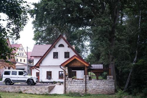 a white truck parked in front of a house at Ubytování pod Dubem in Broumov