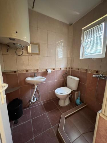 a bathroom with a toilet and a sink at Green Villa in Bar, Susanj