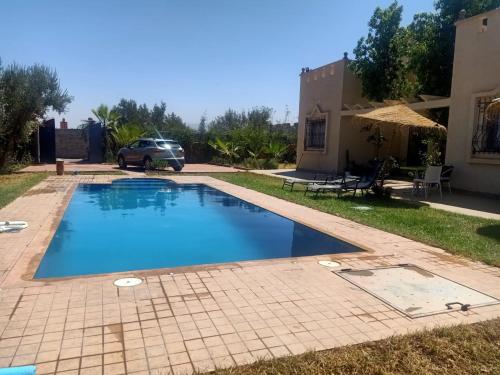a swimming pool in the backyard of a house at Villa de HIMMI in Marrakech