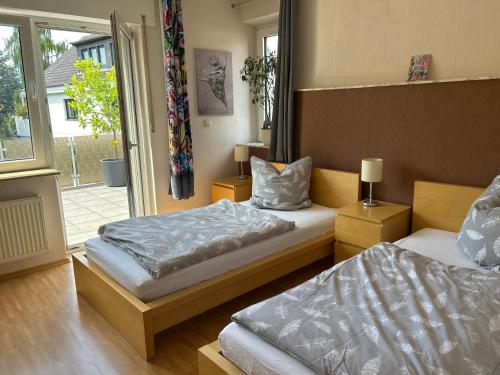 a bedroom with two beds and a window at Gästehaus-Schild in Dormagen