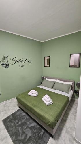 a bedroom with a bed with two towels on it at Gliù Vico in Formia