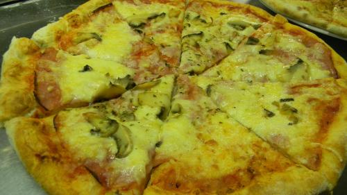 a pizza sitting on top of a table at Hotel Krona Domžale in Domžale