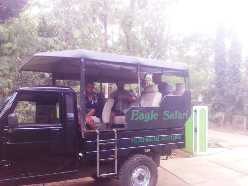 a group of people riding in a golf cart at White House Safari Cottage in Udawalawe
