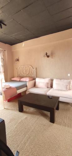 a room with two beds and a coffee table at Aze's Garden suites - Kalkan, Kaş in Kaş