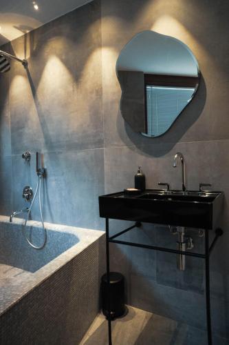 a bathroom with a sink and a mirror on the wall at Horse Shoe House in Chiaverano