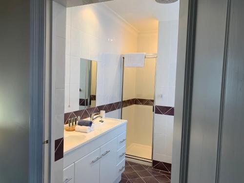 a white bathroom with a sink and a shower at Avon Terrace Guest House in York
