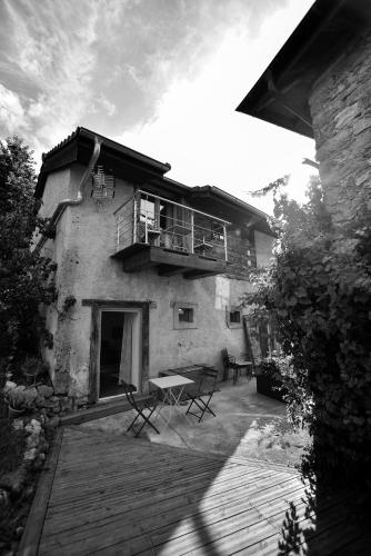 a black and white photo of a building with a patio at Grange du lac in Meillerie