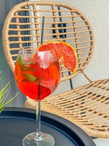 a drink in a glass sitting on a table at ADORNO PRIVATE SUITES Only Adults & Kids 12 Plus in Nea Vrasna