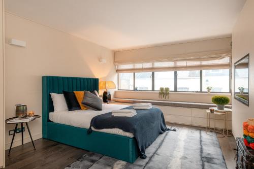 a bedroom with a large bed and a window at Luxury 3BR Home in Belgravia, Near Victoria in London