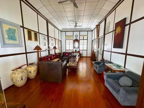 a large living room with couches and tables in it at Hickory Penang Hill in George Town