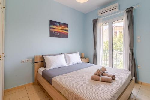a bedroom with a bed with a towel on it at Seaside Escape Apartments - Poseidon in Palaia Fokaia