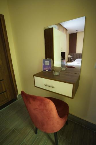a mirror in a room with a desk and a chair at Pyramids Sunshine View in Cairo