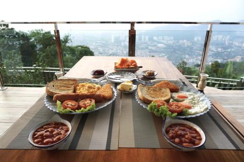 a table topped with plates of food on top of a table at Hickory Penang Hill in George Town