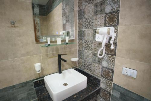 a bathroom with a white sink and a mirror at Pyramids Sunshine View in Cairo