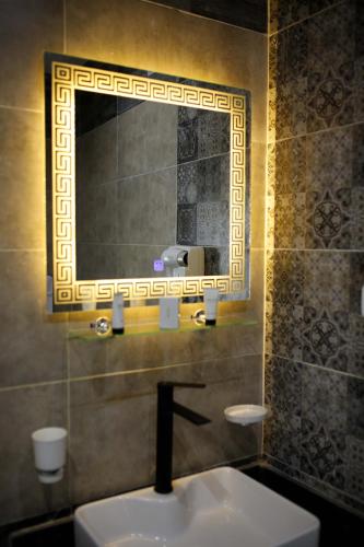 a bathroom with a sink and a mirror at Pyramids Sunshine View in Cairo
