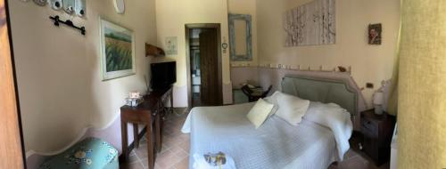a bedroom with a white bed and a chair at Il nuovo fiorile in Benevento