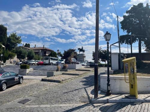 a parking lot with a yellow phone booth on a street at SUN and Sea HOUSE Kavala ammolofoi αμμόλοφοι in Eleftheres