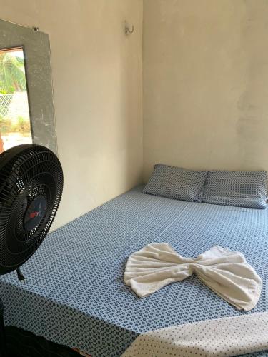a bedroom with a bed with a bow on it at Hospedagem in Barreirinhas