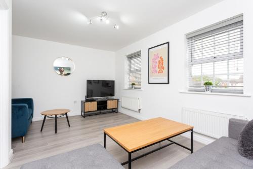 a living room with a couch and a table at Lancers Close House in Leyland
