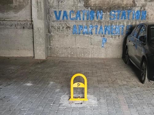 a yellow object on a sidewalk in front of a wall at Vacation Station sea view apartament in Vlorë