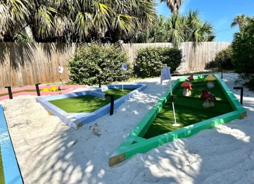 a miniature golf course in the sand in a backyard at The Back Nine in Pensacola Beach