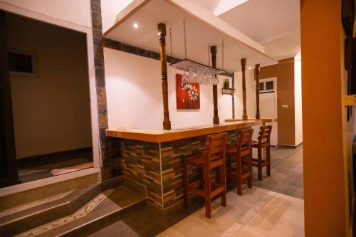 a bar in the middle of a room with chairs at Goshen in Accra