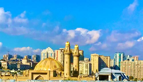 a view of a city with buildings and mosques at SHAH INN Panoramic Apartments Old City F1 Track Принимаем карты МИР in Baku