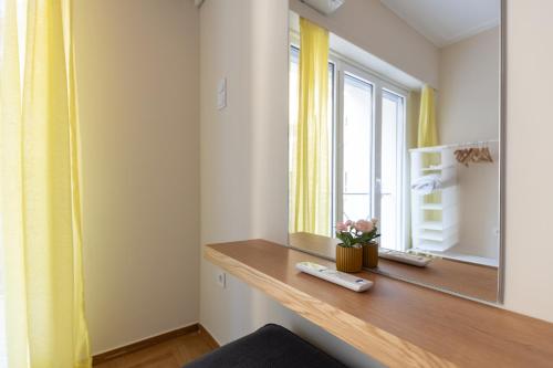 a room with a desk with a mirror and a window at Syntagma sq, luxury & spacious apartment in Athens