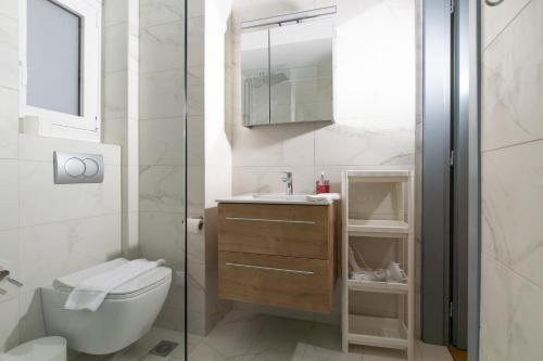 a bathroom with a toilet and a sink at Syntagma sq, luxury & spacious apartment in Athens