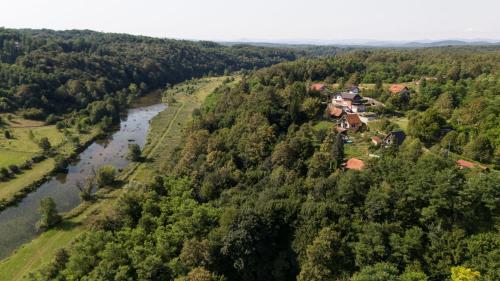 an aerial view of a house in the forest next to a river at Kuća za odmor Casa Huerta in Frketič