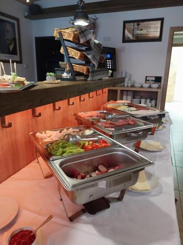 a buffet line with many different types of food at Hotel Zelený potok in Pec pod Sněžkou
