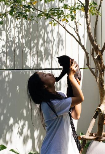 a woman holding a black bird in her mouth at POR Arak in Chiang Mai