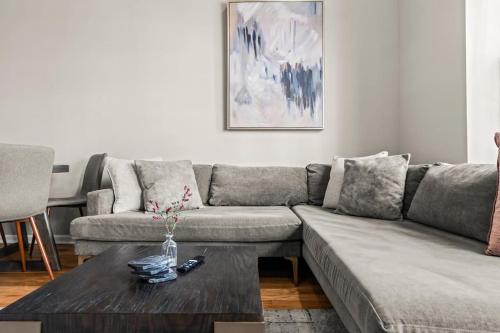 a living room with a couch and a coffee table at Beautiful 1BD With Balcony Hosted By StayRafa - 2F in Philadelphia