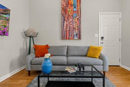 a living room with a couch and a table at StayRafa At 261 4R in Philadelphia