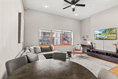 a living room with a table and a tv at Beautiful 1BD With Balcony Hosted By StayRafa - 2F in Philadelphia