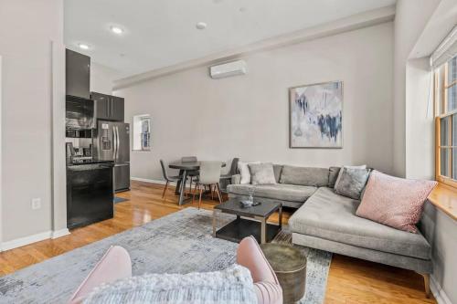 a living room with a couch and a table at Beautiful 1BD With Balcony Hosted By StayRafa - 2F in Philadelphia