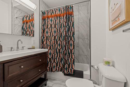 a bathroom with a shower curtain and a toilet at StayRafa At 261 4R in Philadelphia