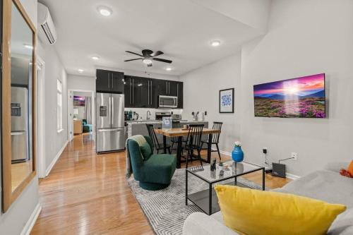 a living room with a couch and a table at StayRafa At 261 4R in Philadelphia