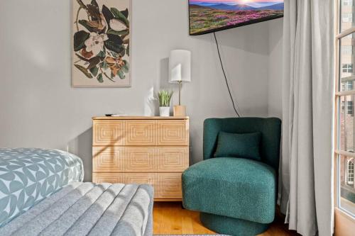 a bedroom with a bed and a chair and a dresser at StayRafa At 261 4R in Philadelphia