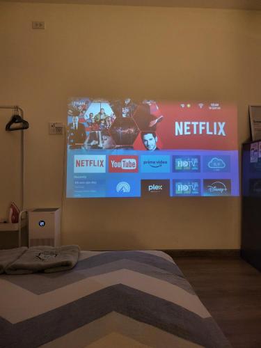 a bedroom with a netflix sign on the wall at LoCo Studio with Netflix and Self Checkin in Ho Chi Minh City