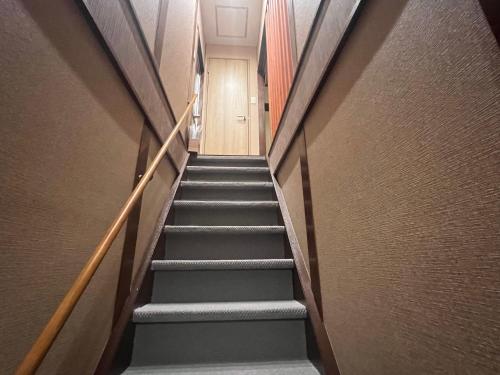a flight of stairs in a building at 关西机场难波梅田直达花園町の夢旅人 in Osaka