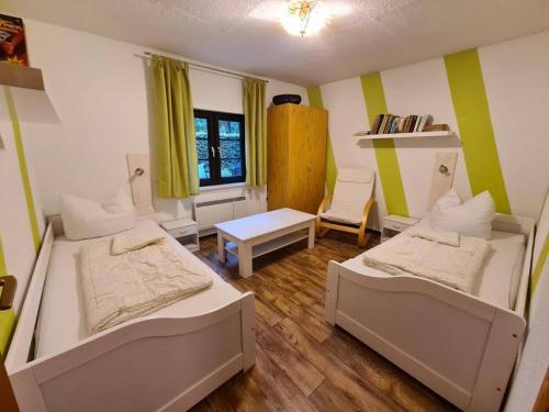 a room with two beds and a table in it at Haus Eckstein in Lohme