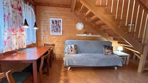 a living room with a blue couch and a table at Letnisko Laba in Pobierowo