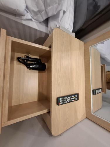 a bed room with a wooden cabinet with a mirror at Jakarta goldcoast seaview apartment in Jakarta